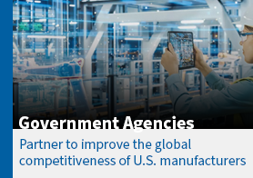 woman in a hard hat holding an ipad looking at robots